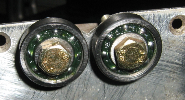2 bearings mounted on a metal plate